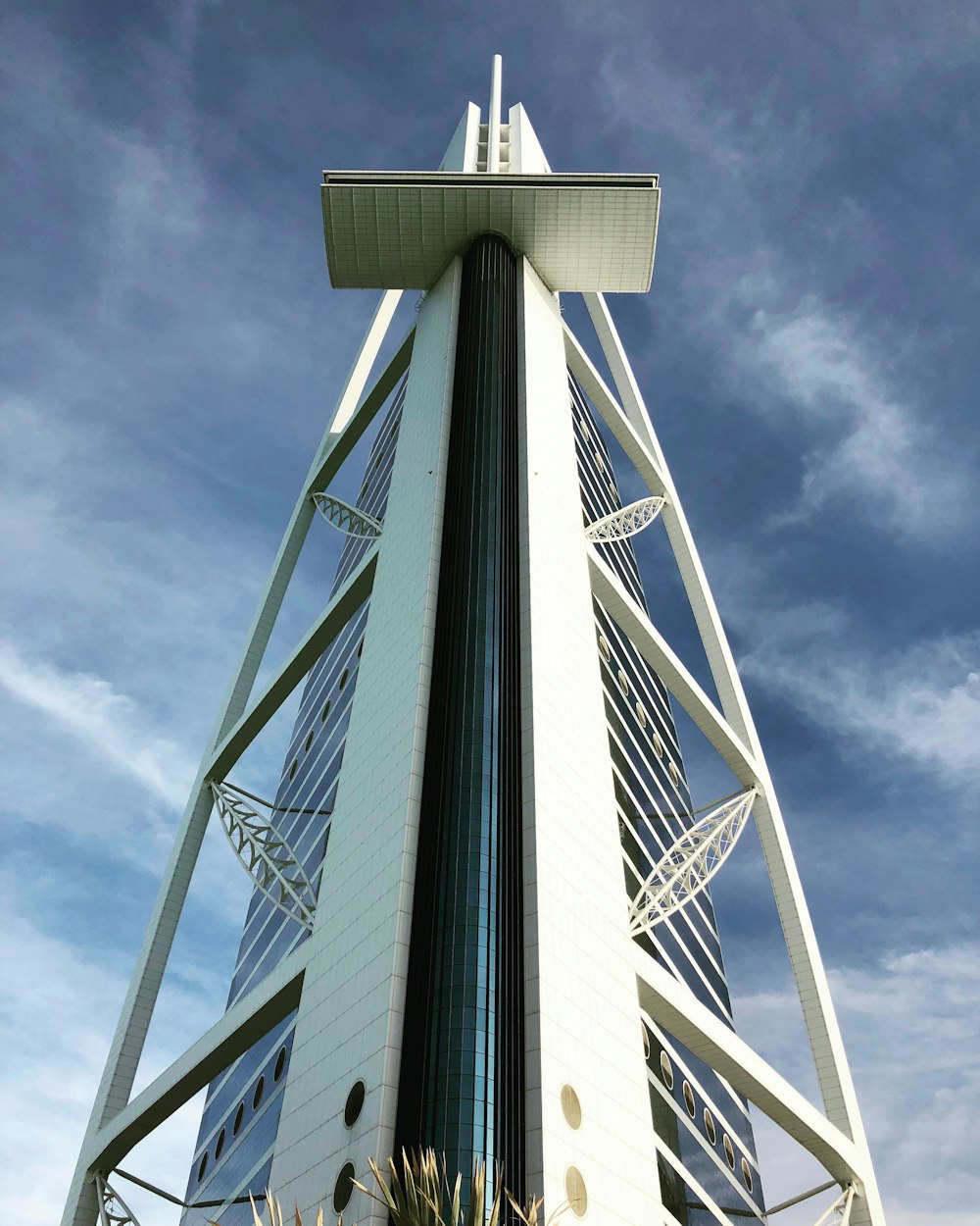 a tall white building with a sky background