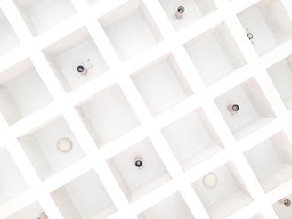 a group of white boxes with black and white buttons on them