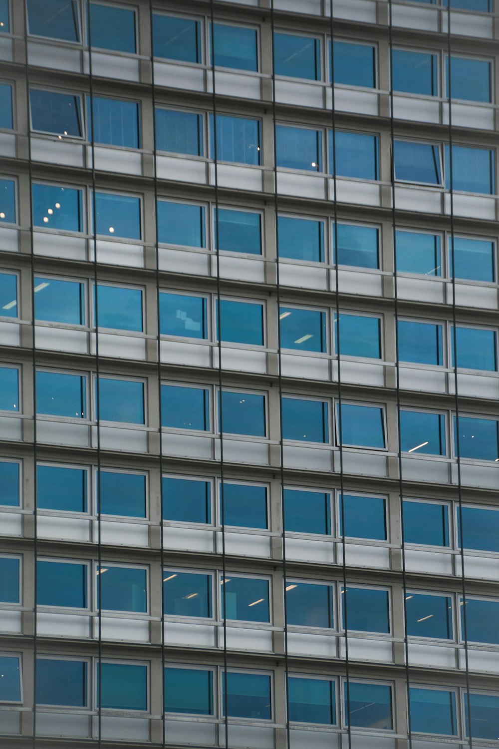 an airplane flying in front of a very tall building