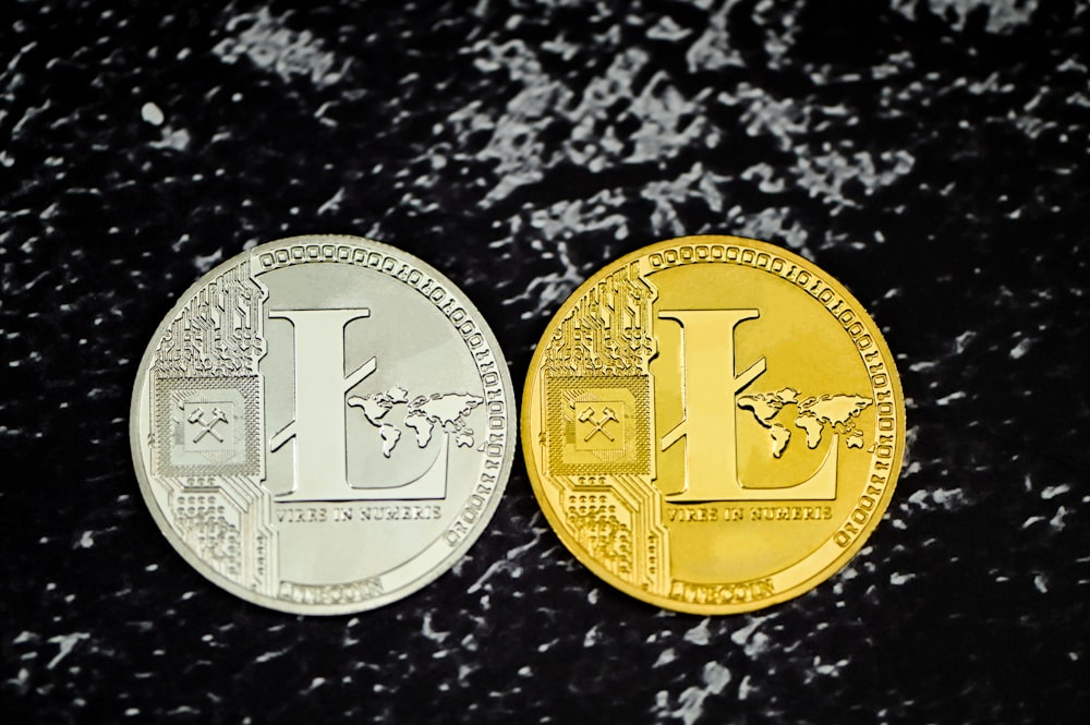 two gold and silver coins sitting side by side