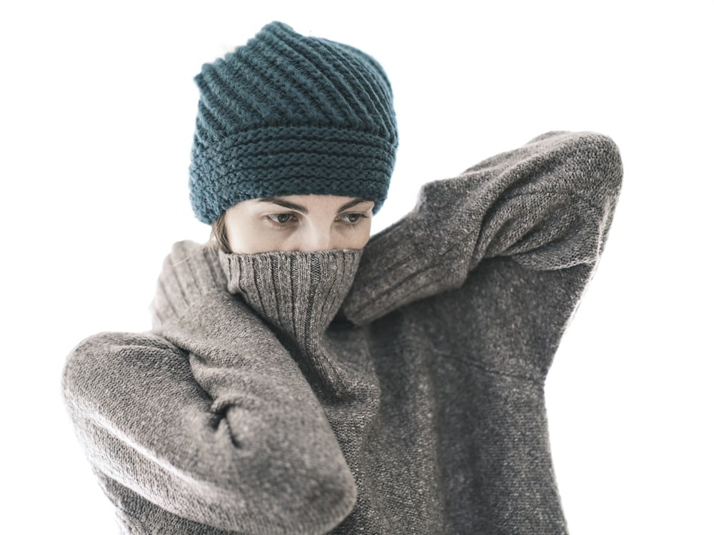 a woman wearing a knitted hat and scarf