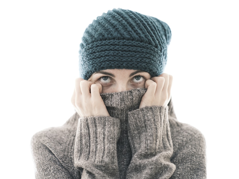 a woman covering her face with her hands