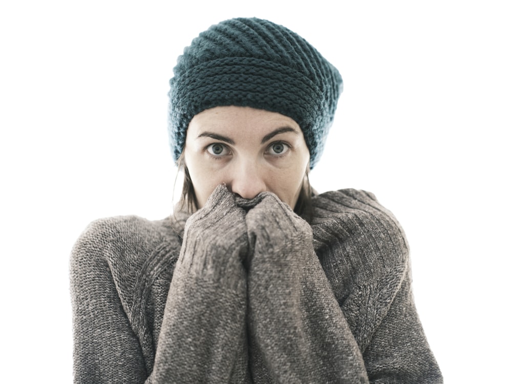 a woman covers her mouth with her hands