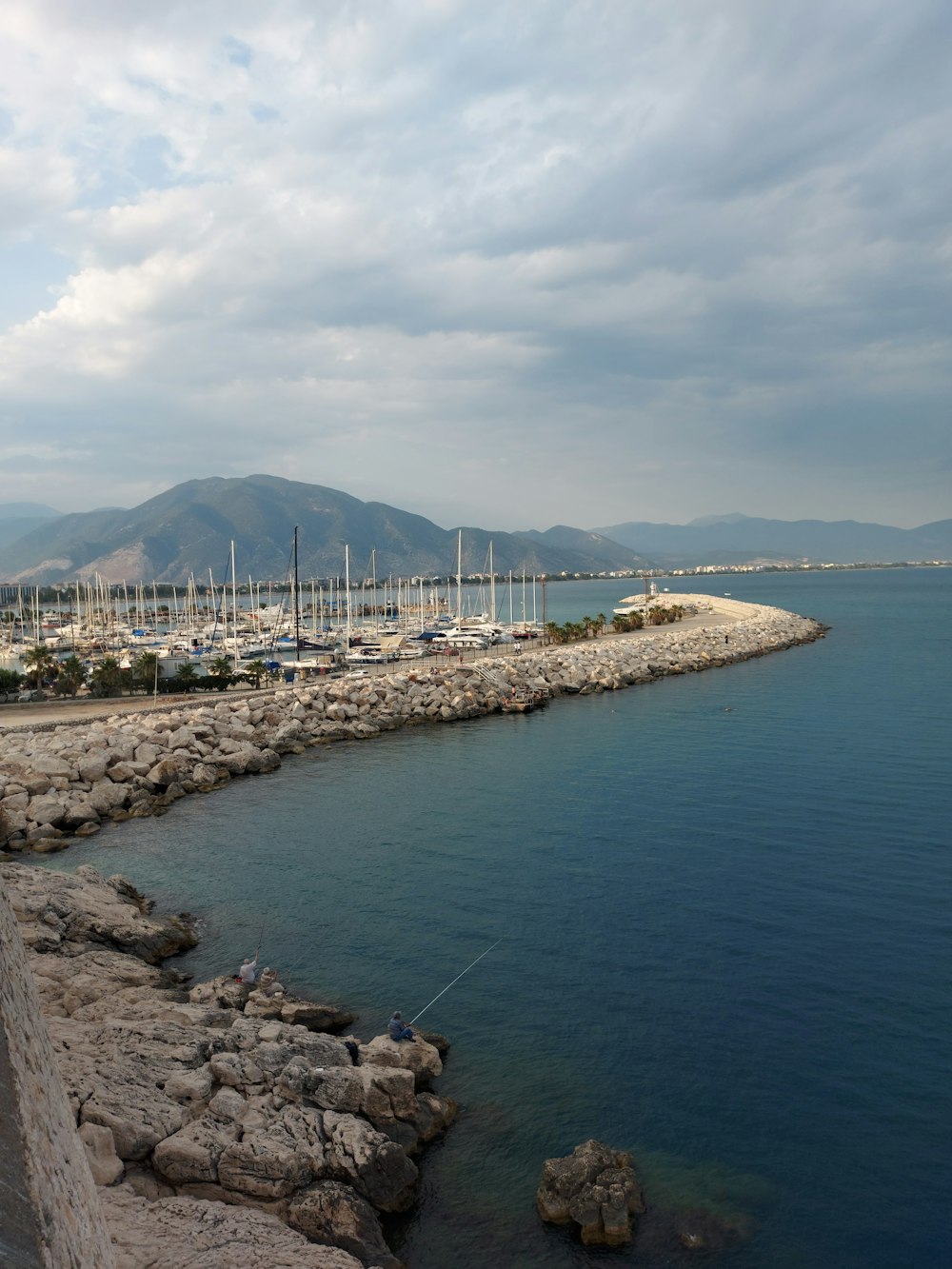 a body of water next to a rocky shore