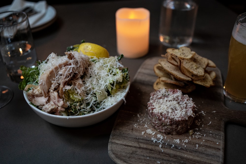 a plate of food and a glass of beer on a table