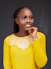 a woman in a yellow top posing for a picture