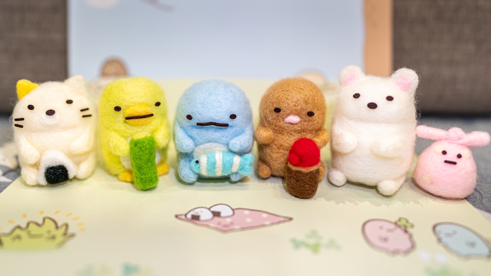 a group of stuffed animals sitting on top of a table
