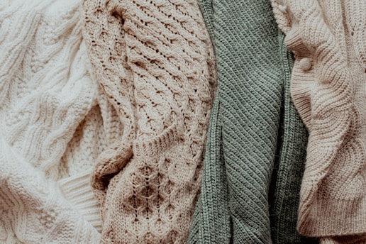 a pile of sweaters sitting next to each other