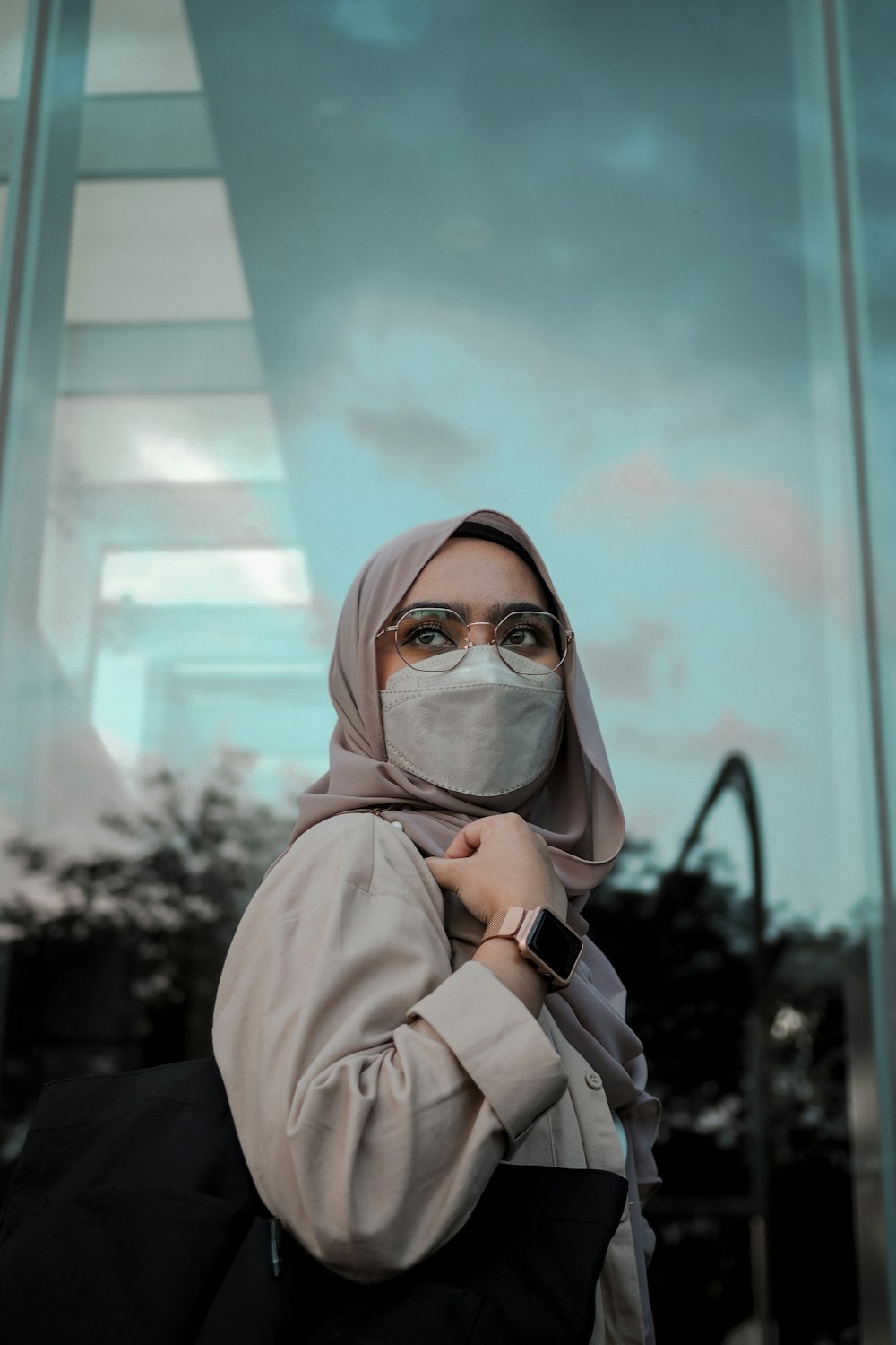 a woman in a hijab and a face mask