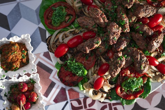 A delicious plate of grilled kebabs served with fresh vegetables.