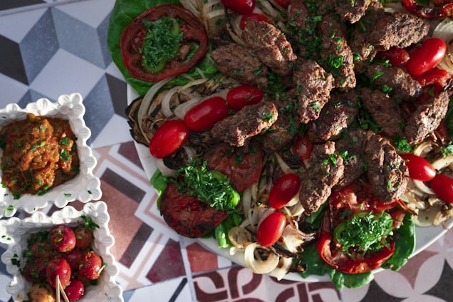 A vibrant table set with Turkish and Arabic dishes, showcasing kebabs, shawarma, and colorful salads.
