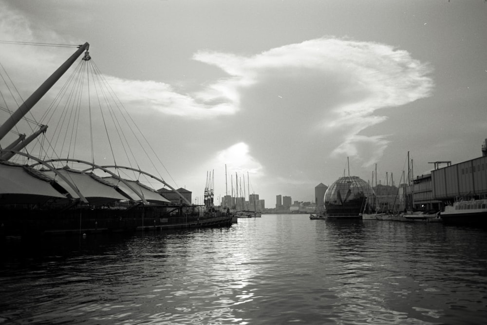 a black and white photo of boats in a harbor