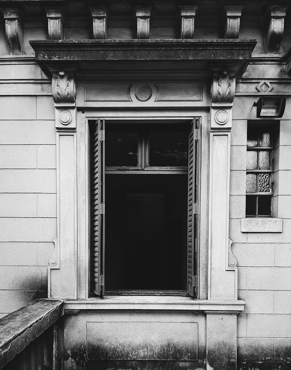 a black and white photo of an open window