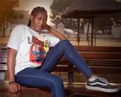 Casual streetwear outfit laid out on a wooden bench with greenery in the background.