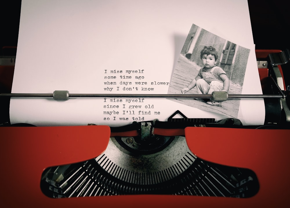 an old typewriter with a picture of a child on it