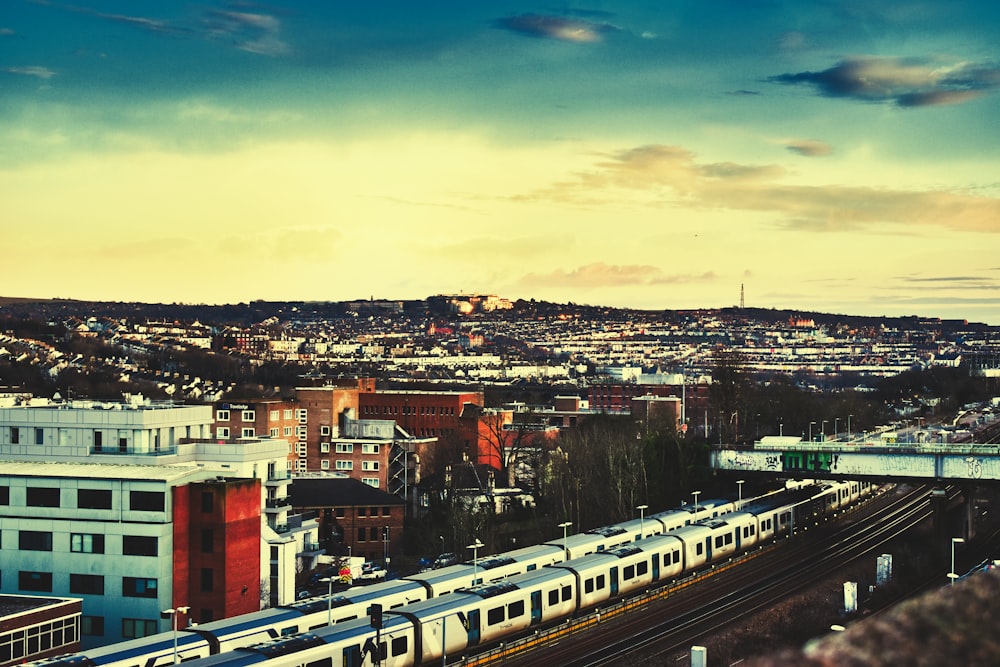 a train traveling through a city next to tall buildings