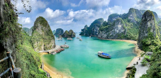 Boats on the turquoise water of Ha Long Bay surrounded by limestone karst islands