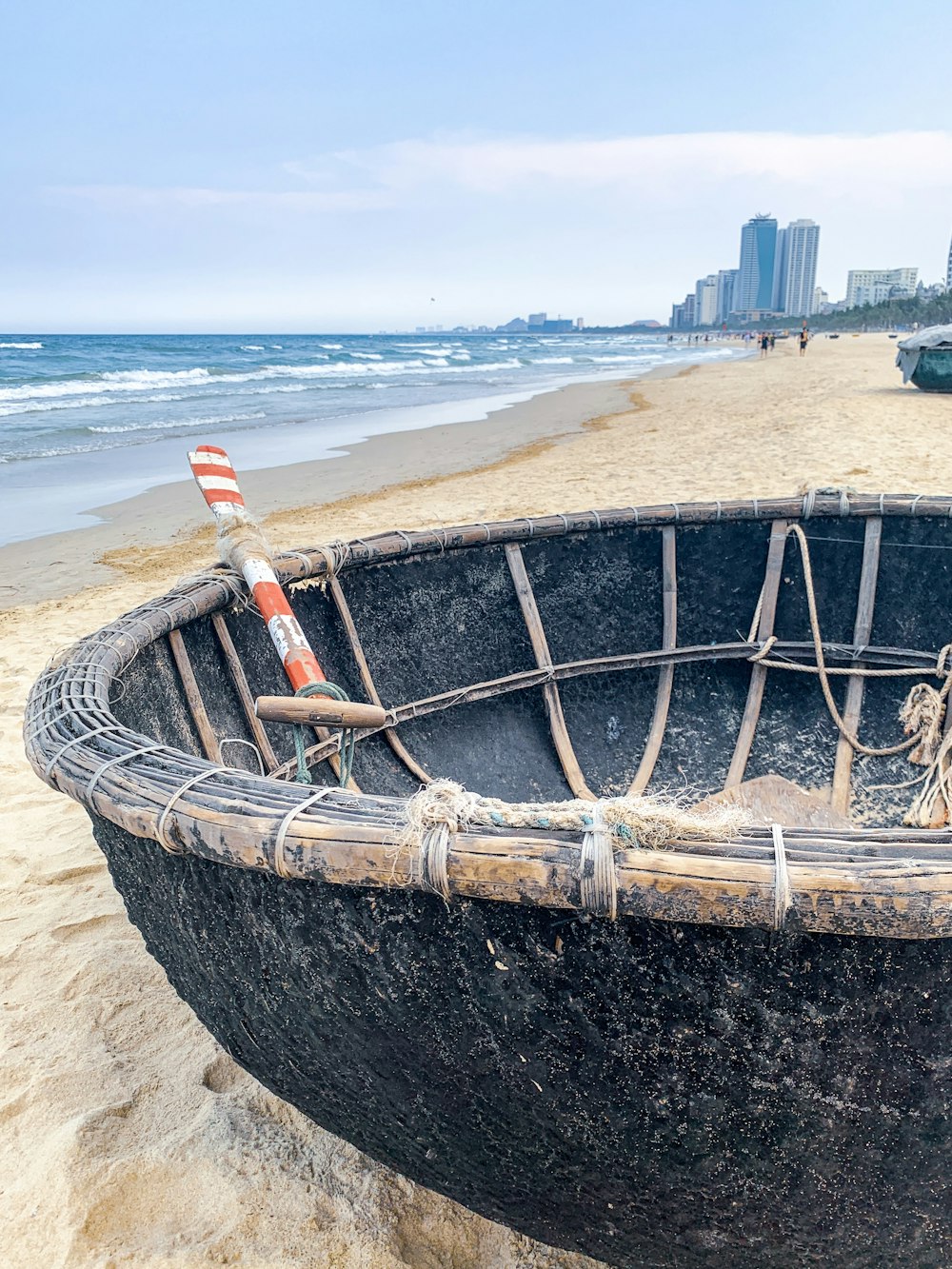 a boat sitting on top of a sandy beach