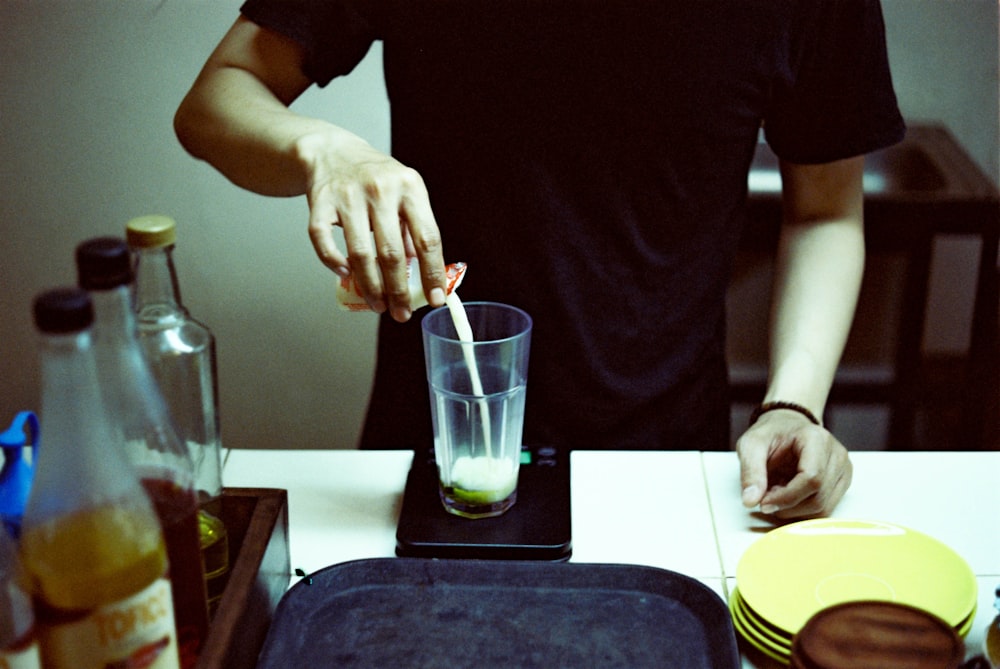 a man is making a drink with a straw