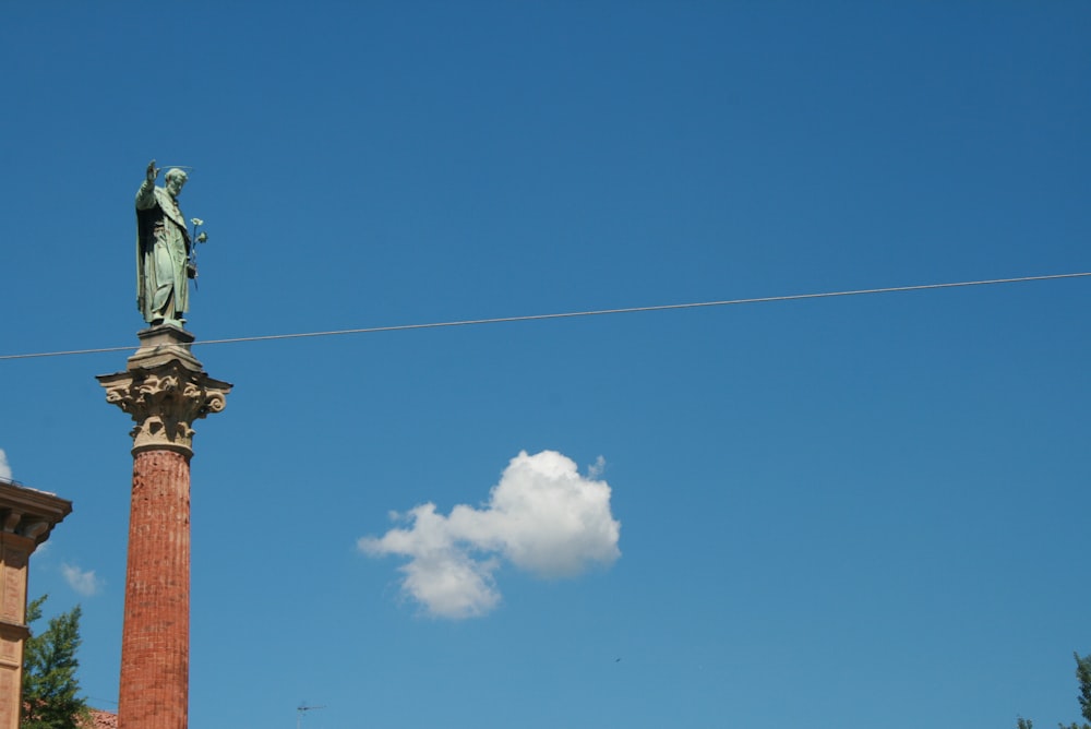 a statue of a man on top of a pillar