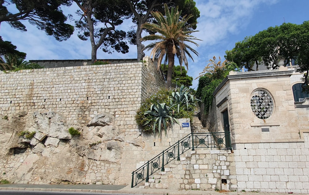 a stone building with a palm tree on top of it