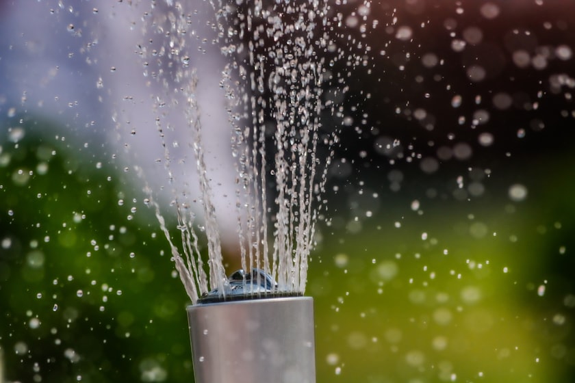 Water bursting from a broken pipe under pressure