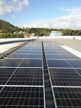 A bright rooftop with sleek solar panels under a clear blue sky.