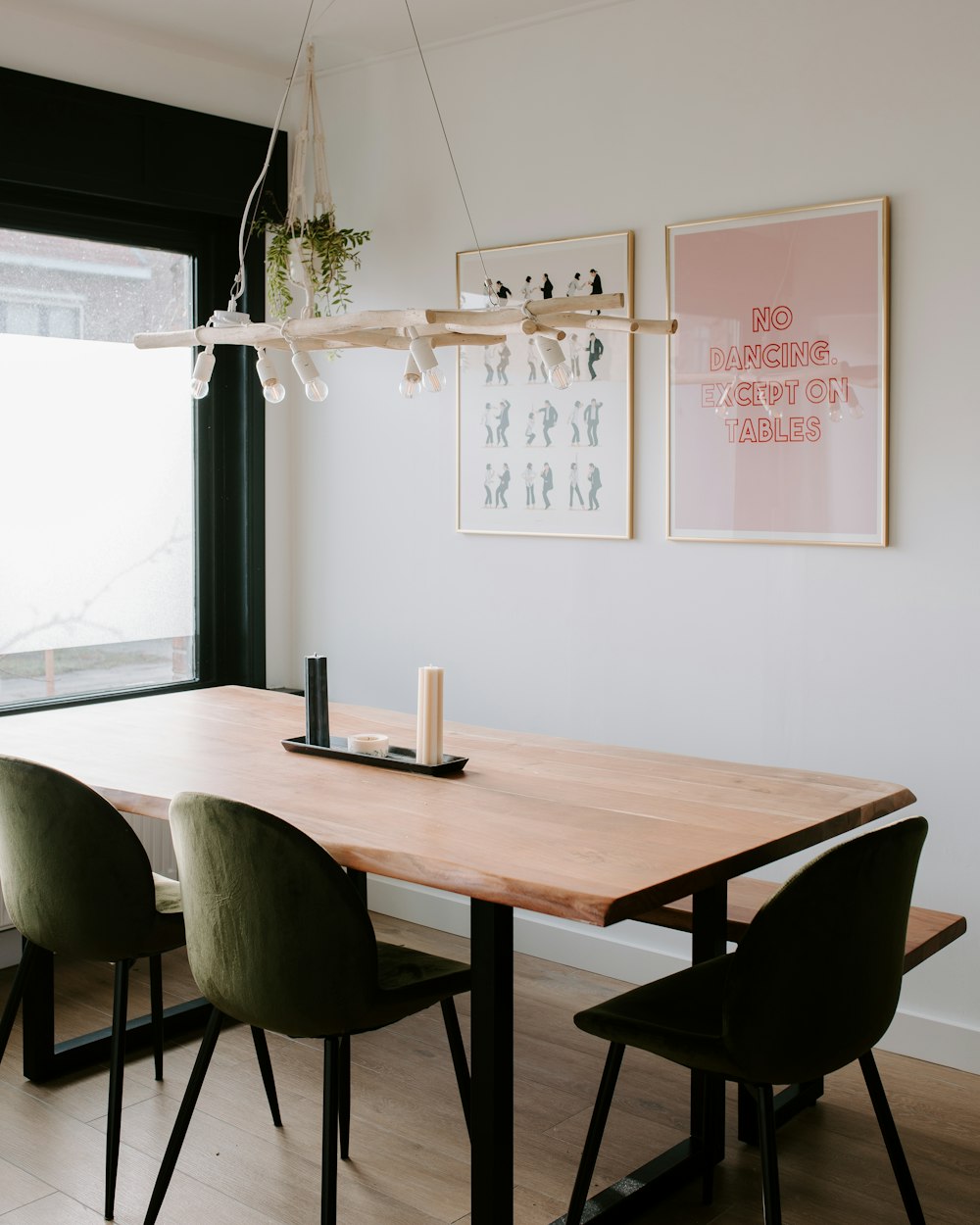 a wooden table with green chairs in a room