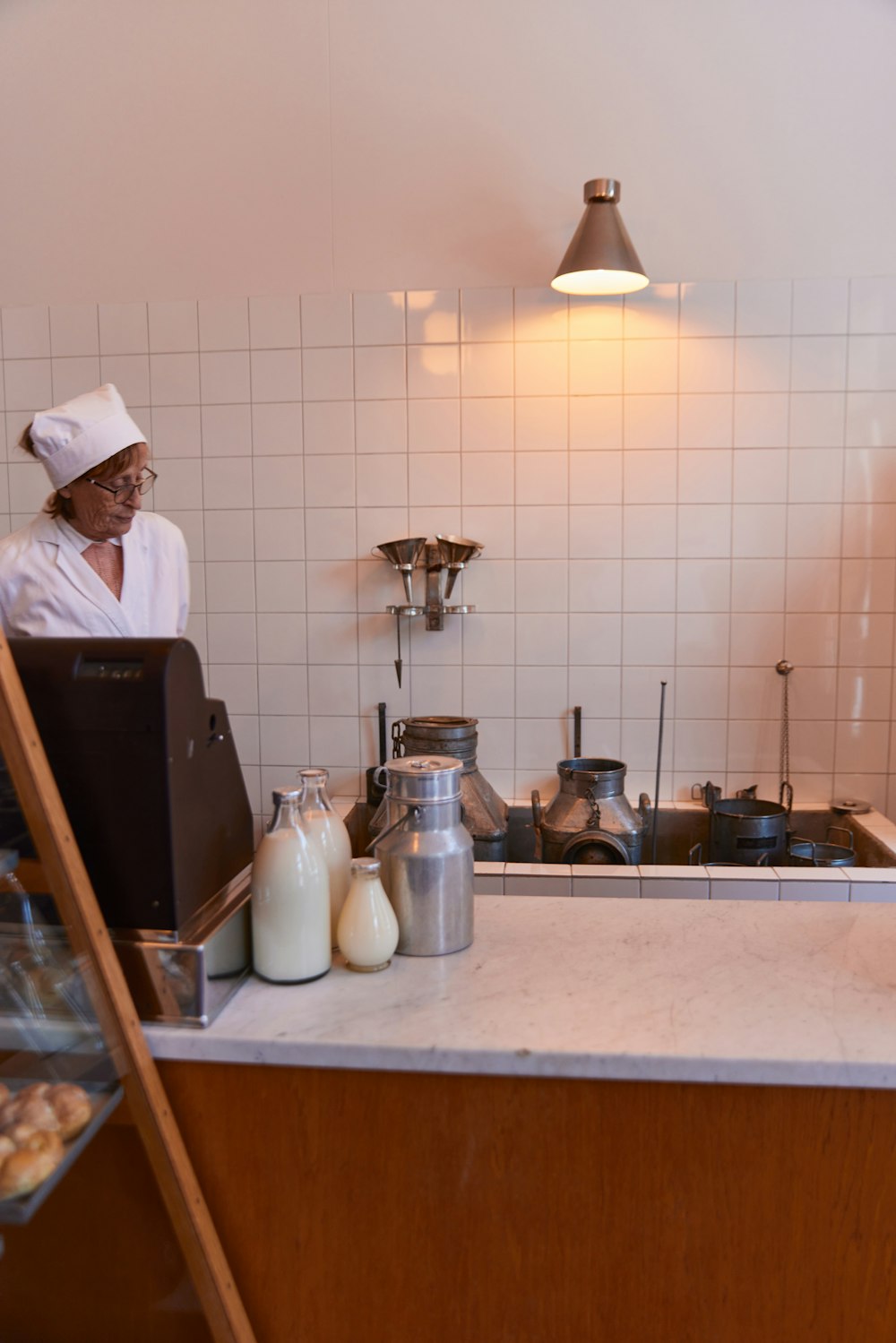 a woman standing in a kitchen next to a counter