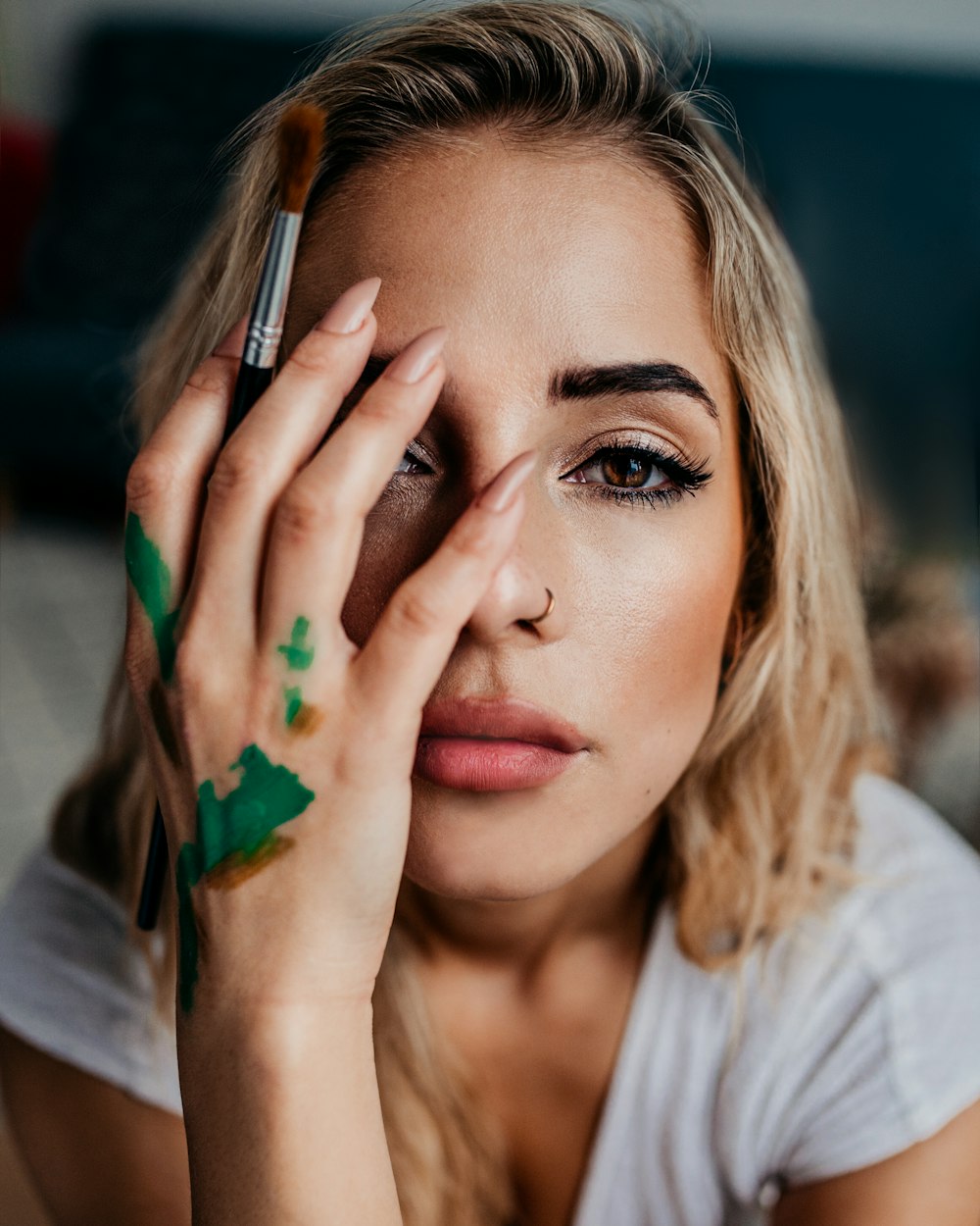 a woman holding a brush to her eye