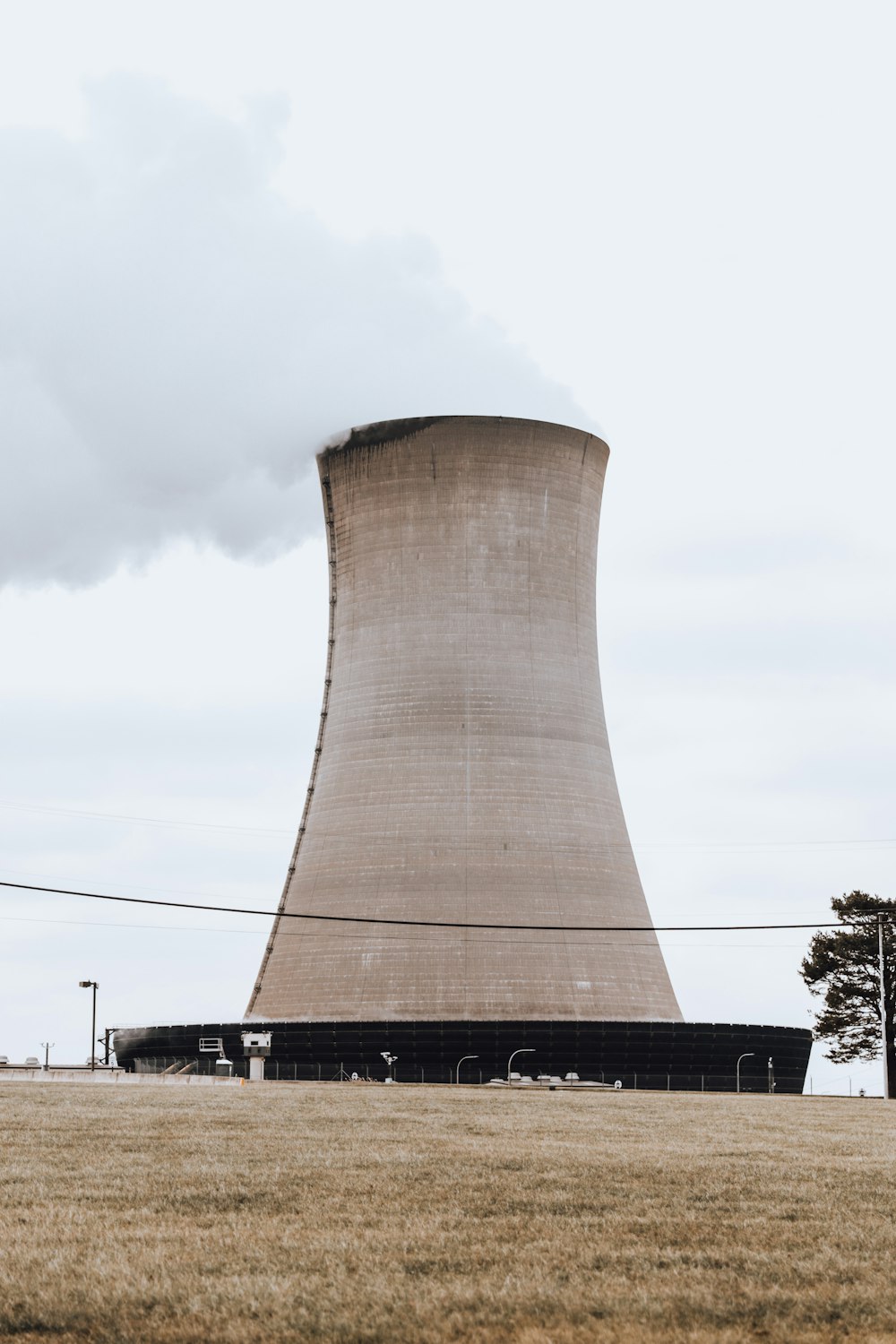 a large cooling plant sitting in the middle of a field