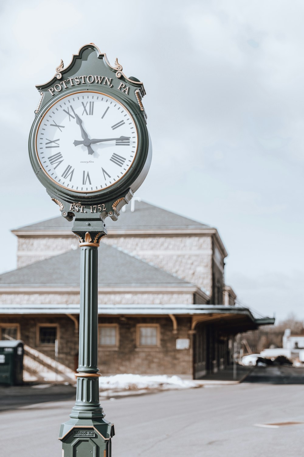 a clock on a pole in front of a building