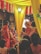 A wedding ceremony with several people dressed in traditional attire. The setting includes vibrant colors with yellow drapes and red and white flower decorations. A man is seated on a throne-like chair wearing ceremonial clothing and a turban, while a woman in a red saree stands nearby. The ambiance is festive, with other people surrounding the scene.
