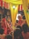 A wedding ceremony with several people dressed in traditional attire. The setting includes vibrant colors with yellow drapes and red and white flower decorations. A man is seated on a throne-like chair wearing ceremonial clothing and a turban, while a woman in a red saree stands nearby. The ambiance is festive, with other people surrounding the scene.