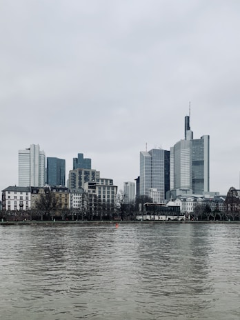 a large body of water with a city in the background