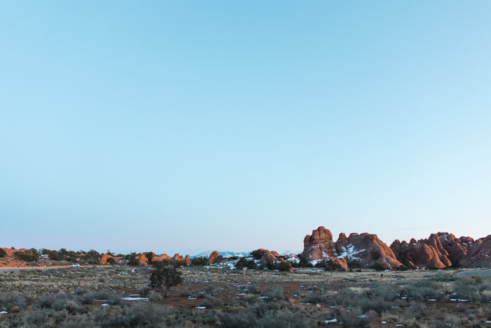 a mountain range in the distance with a blue sky in the background