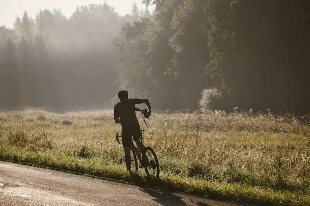 a man riding a bike down a country road