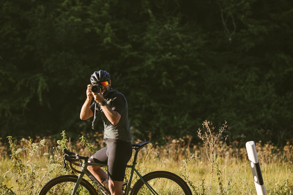 a man riding a bike while talking on a cell phone