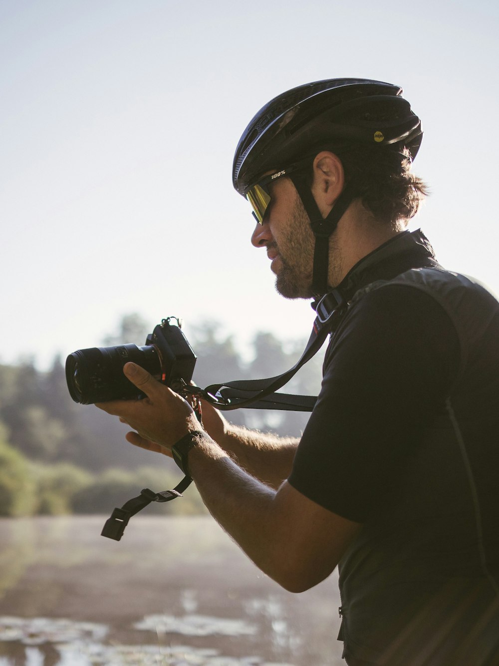a man wearing a helmet and holding a camera