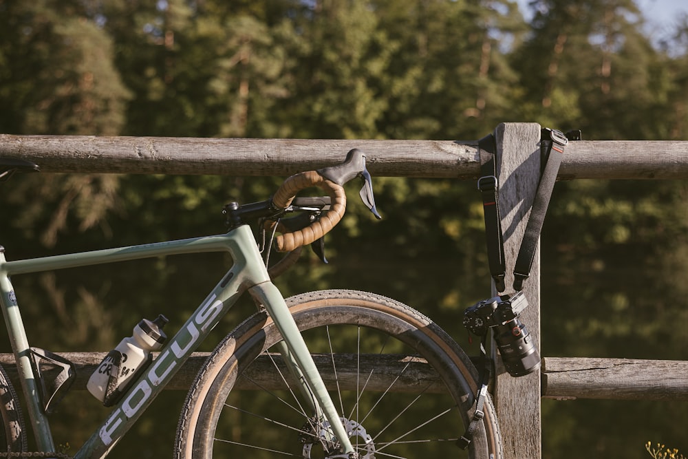 a bike parked next to a wooden fence