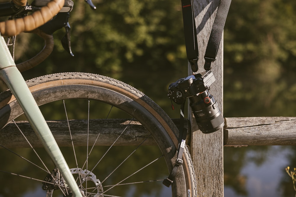 a bicycle parked next to a wooden fence