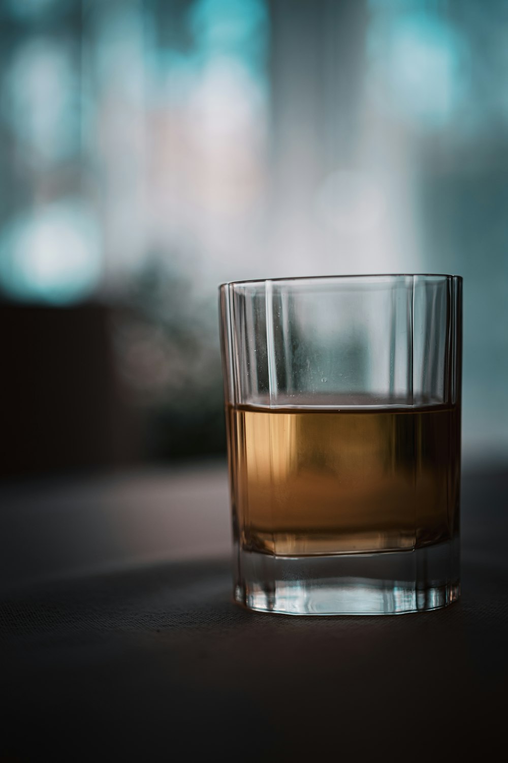 a glass of alcohol sitting on a table