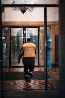 a man walking into a building through a glass door