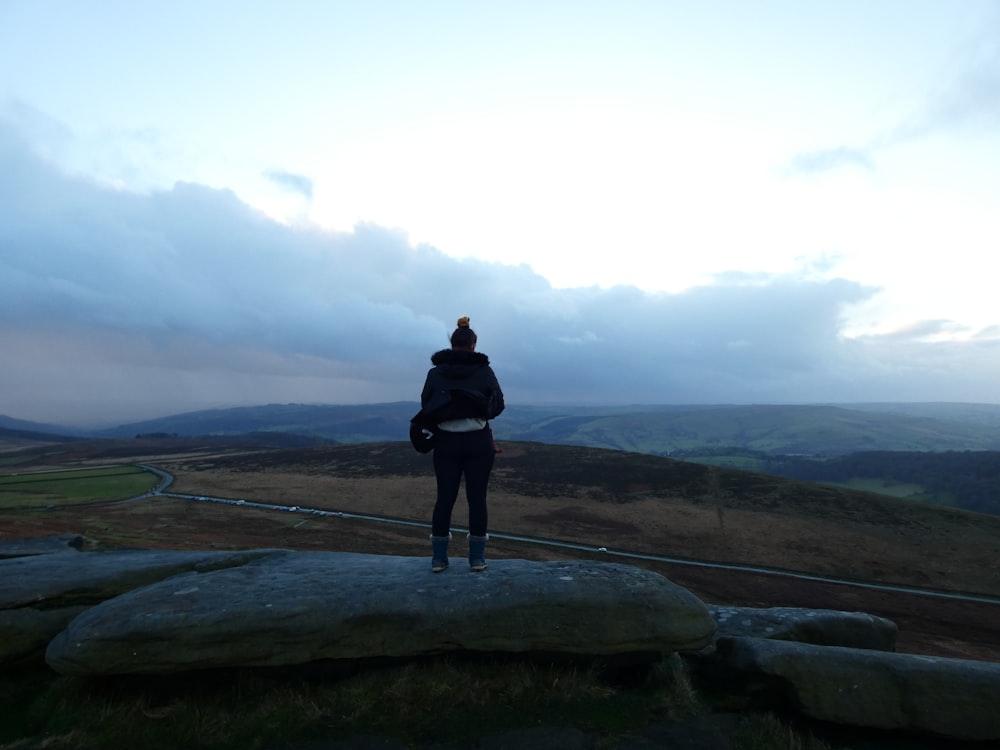 a person standing on top of a hill