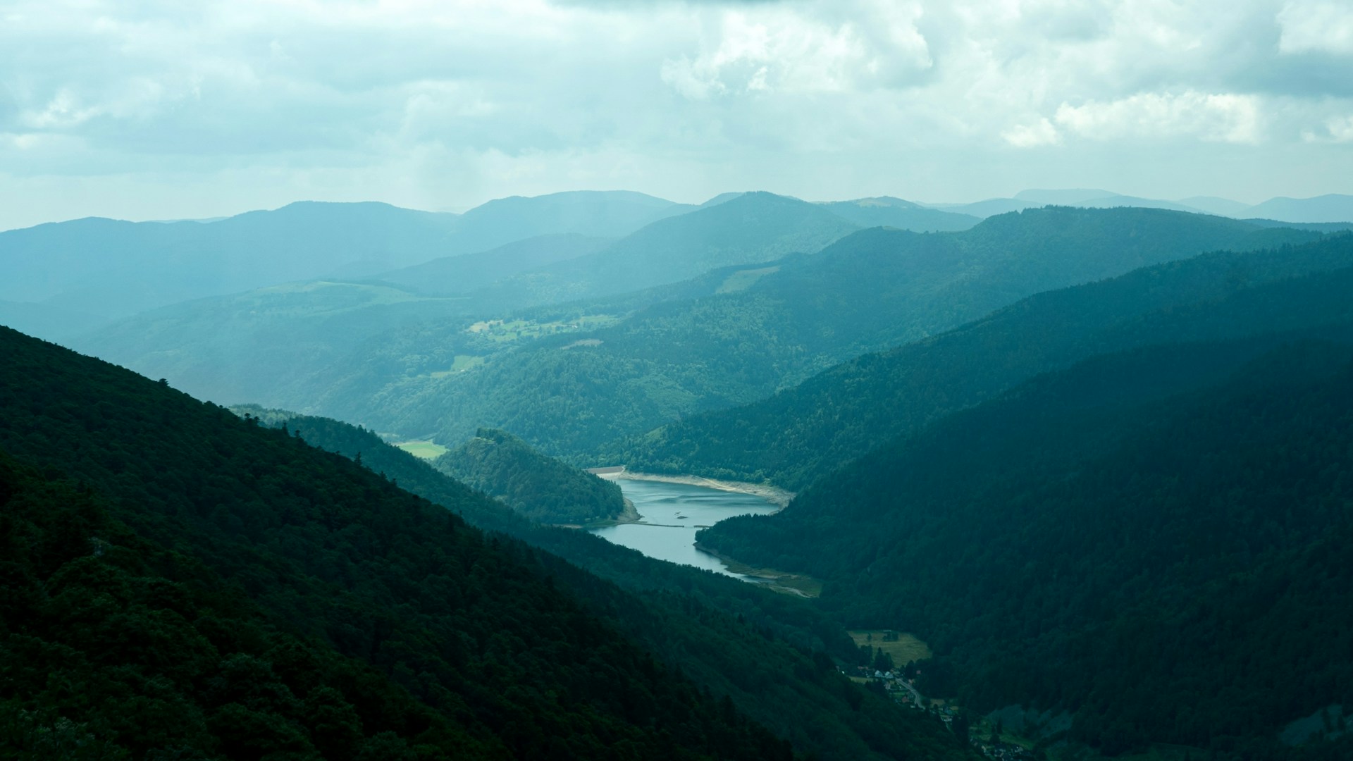 a view of a valley with a river running through it