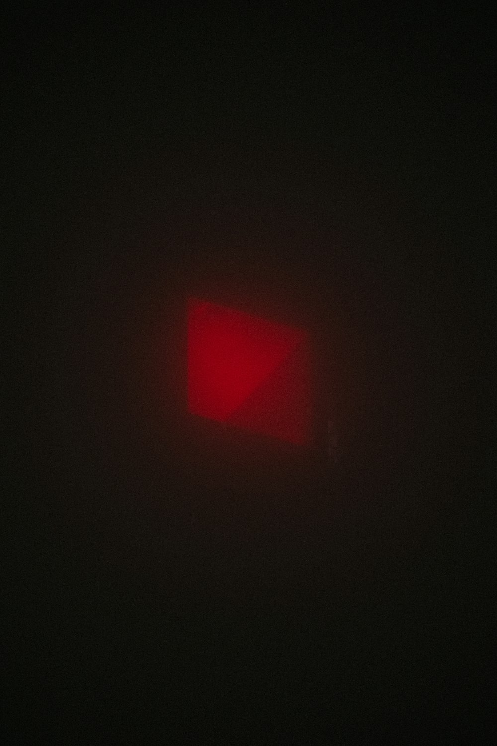 a red light is shining in the dark
