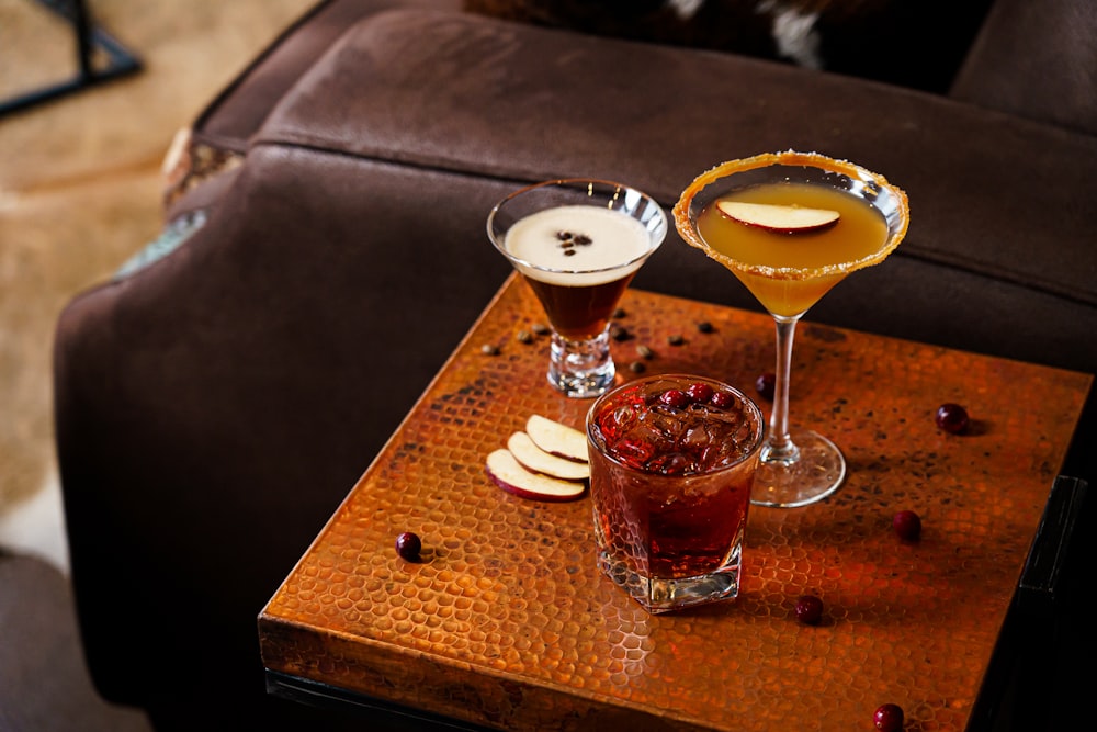 a couple of drinks sitting on top of a wooden table