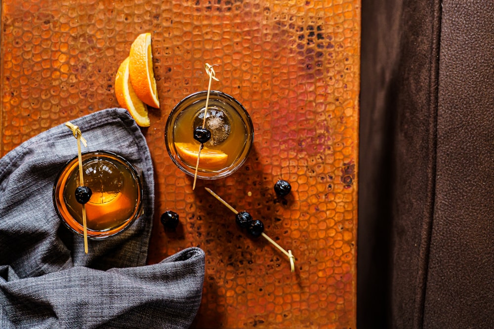 a couple of glasses filled with orange juice