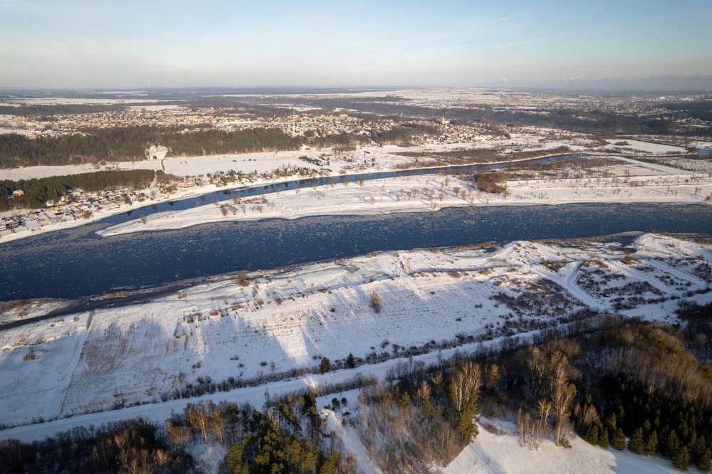 an aerial view of a river and a snowy landscape
