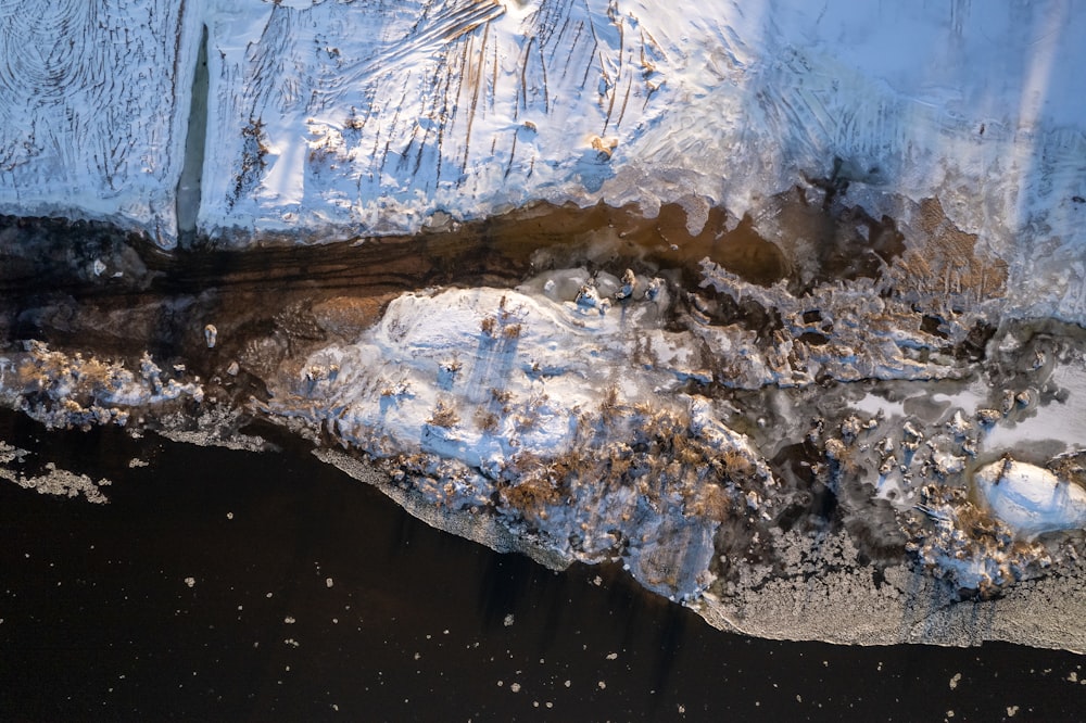 a large iceberg with snow on the top of it